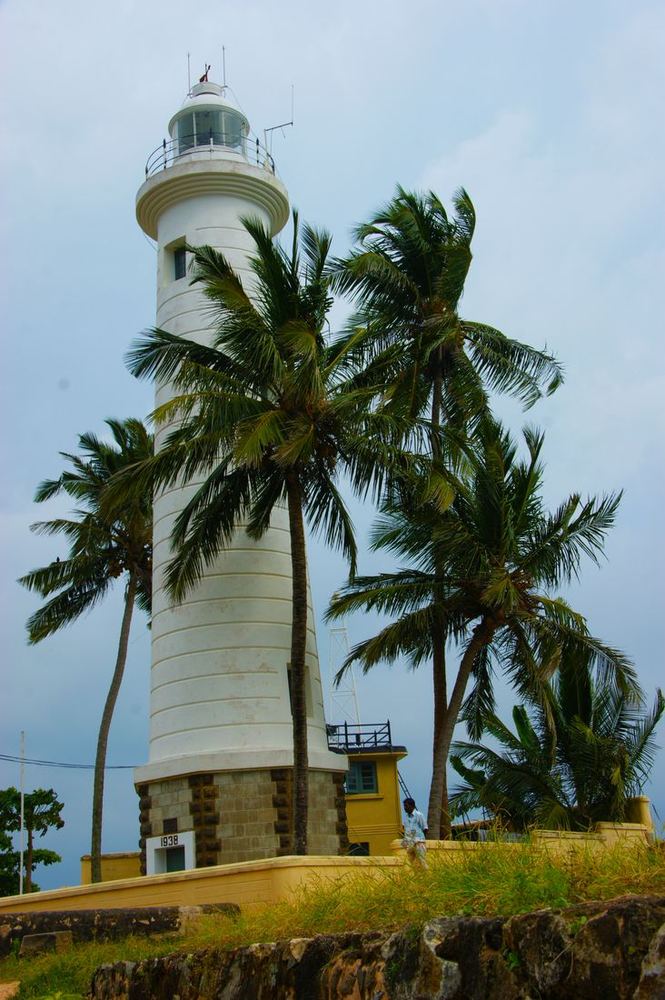 Galle Lighthouse among palm trees